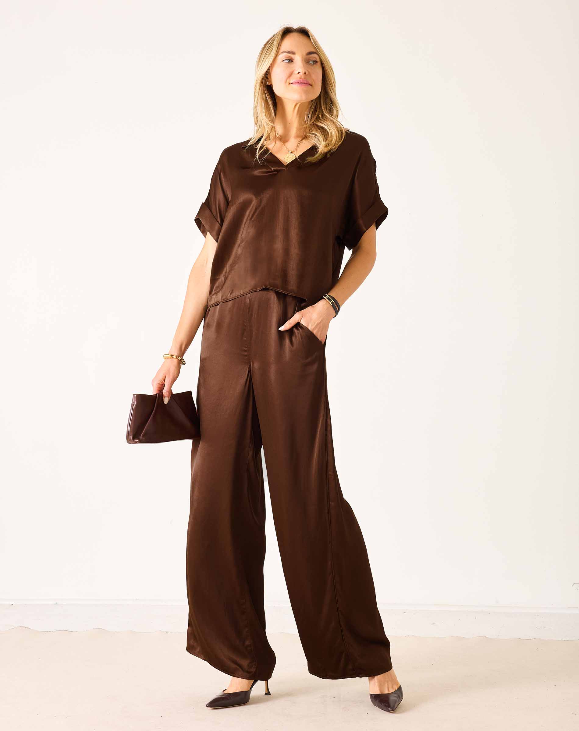 Chocolate brown silk-blend wide-leg pants with a relaxed fit and soft drape.