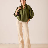 Hazel green puff sleeve top with a gathered waist and relaxed fit.
