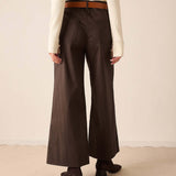 Espresso brown wide-leg pleated trouser pants in a textured woven fabric.
