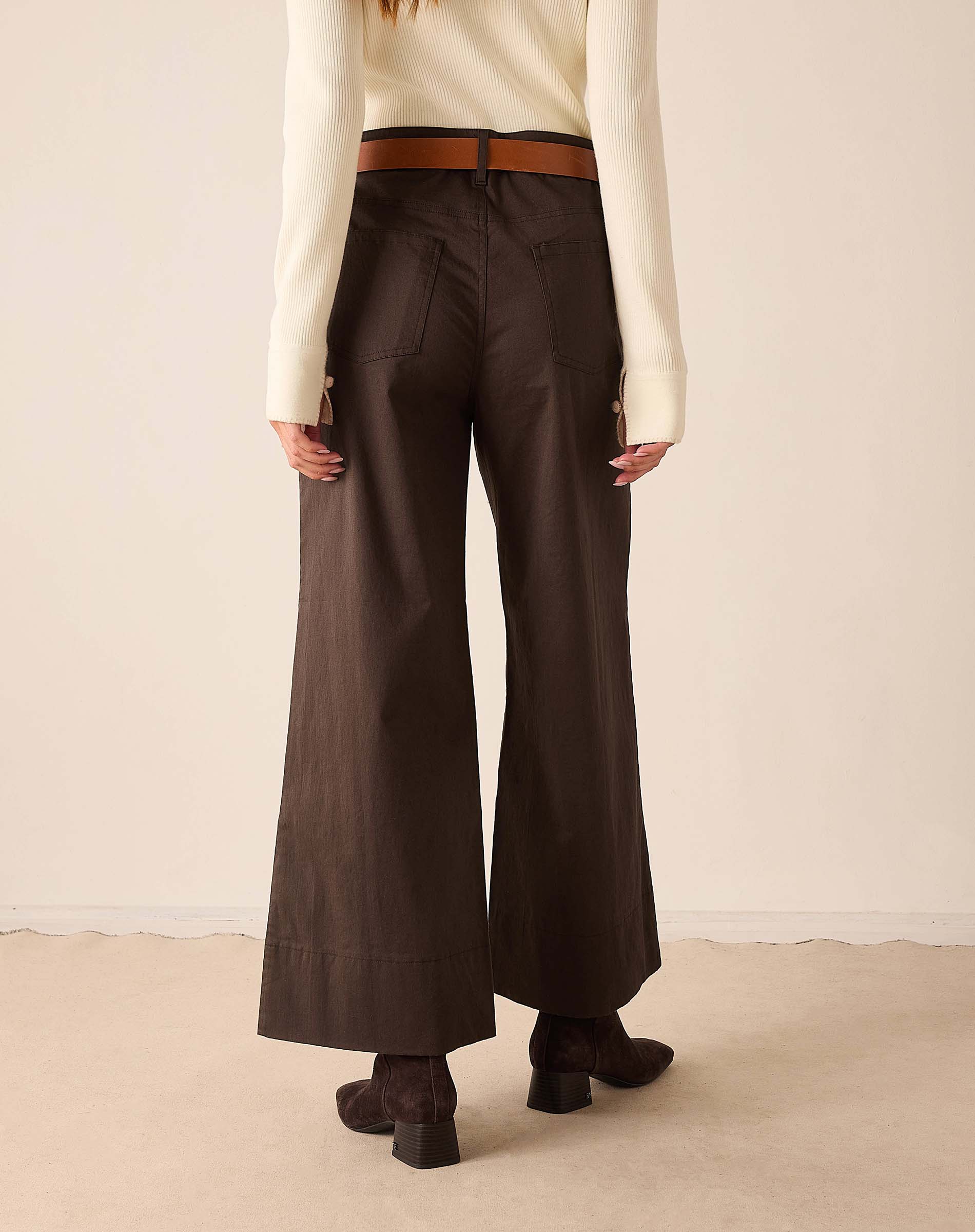Espresso brown wide-leg pleated trouser pants in a textured woven fabric.
