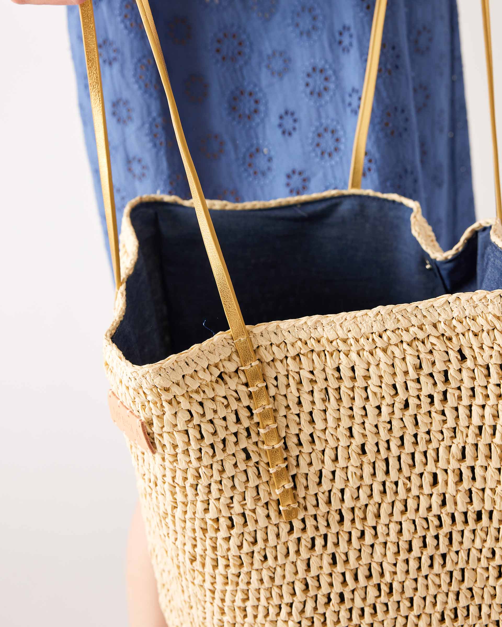 inside of sun chaser straw tote with navy lining