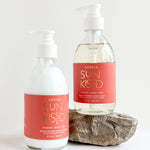 sun kissed liquid hand soap and shea lotion laying on a white background