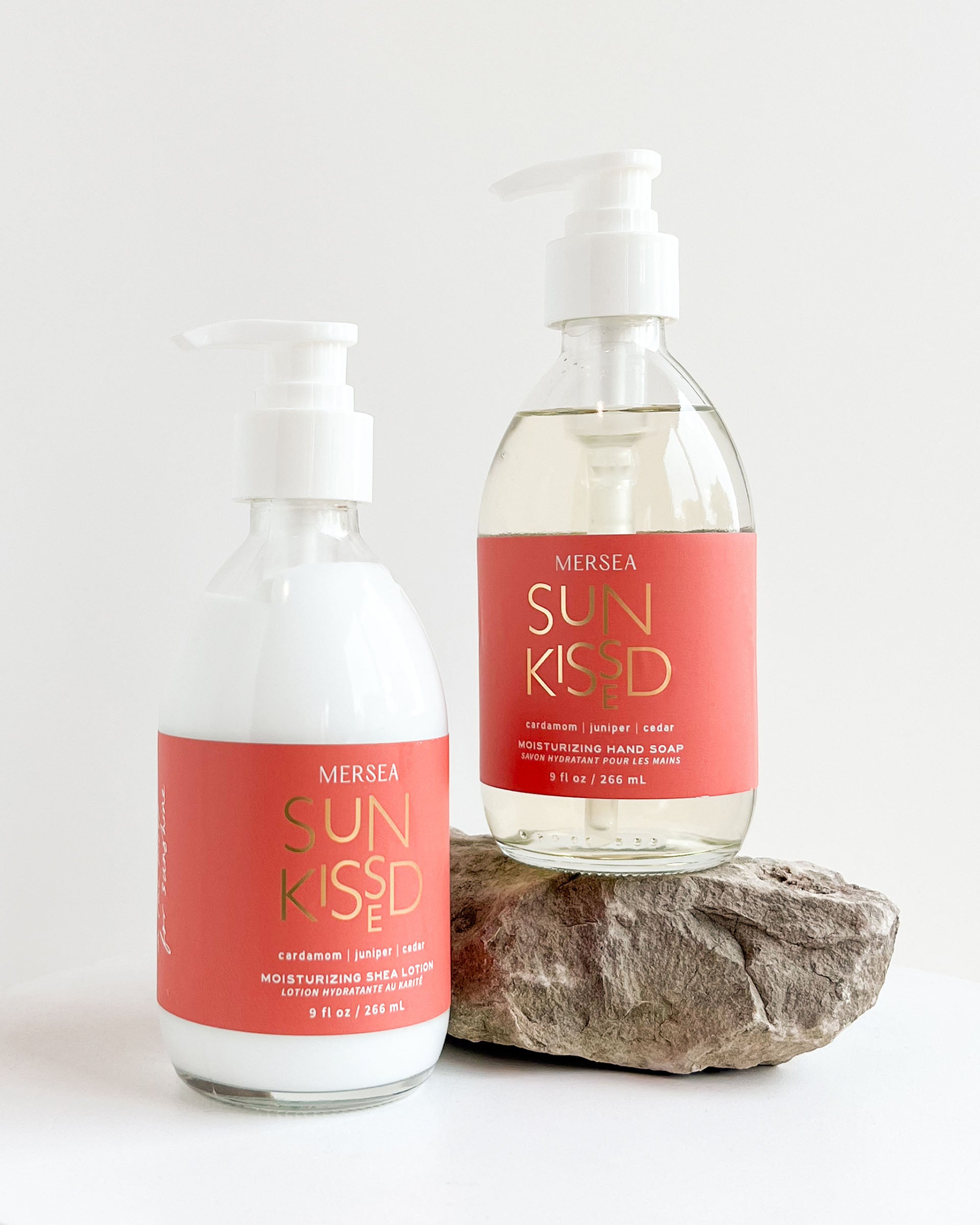 sun kissed liquid hand soap and shea lotion laying on a white background