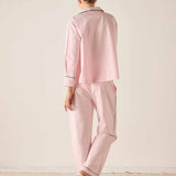 Person wearing a pink pajama set with a white background