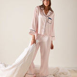 Woman wearing a pink striped pajama set with matching headband on a white background