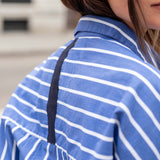 Blue and white horizontal stripe tunic with a navy contrast trim detail.