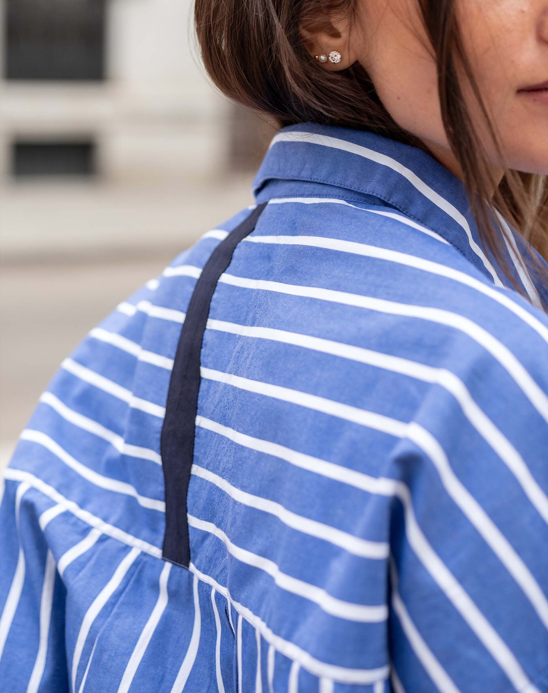 Blue and white horizontal stripe tunic with a navy contrast trim detail.