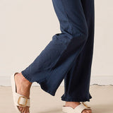 Navy pants worn by a person on a light background