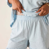 Light blue pajama set with shorts and top on a neutral background