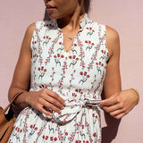 Woman wearing a floral dress against a pink background