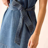 Denim dress with a belt on a plain background