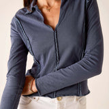 Atlas blue relaxed fit jersey knit polo tee with ruffled placket and hem.