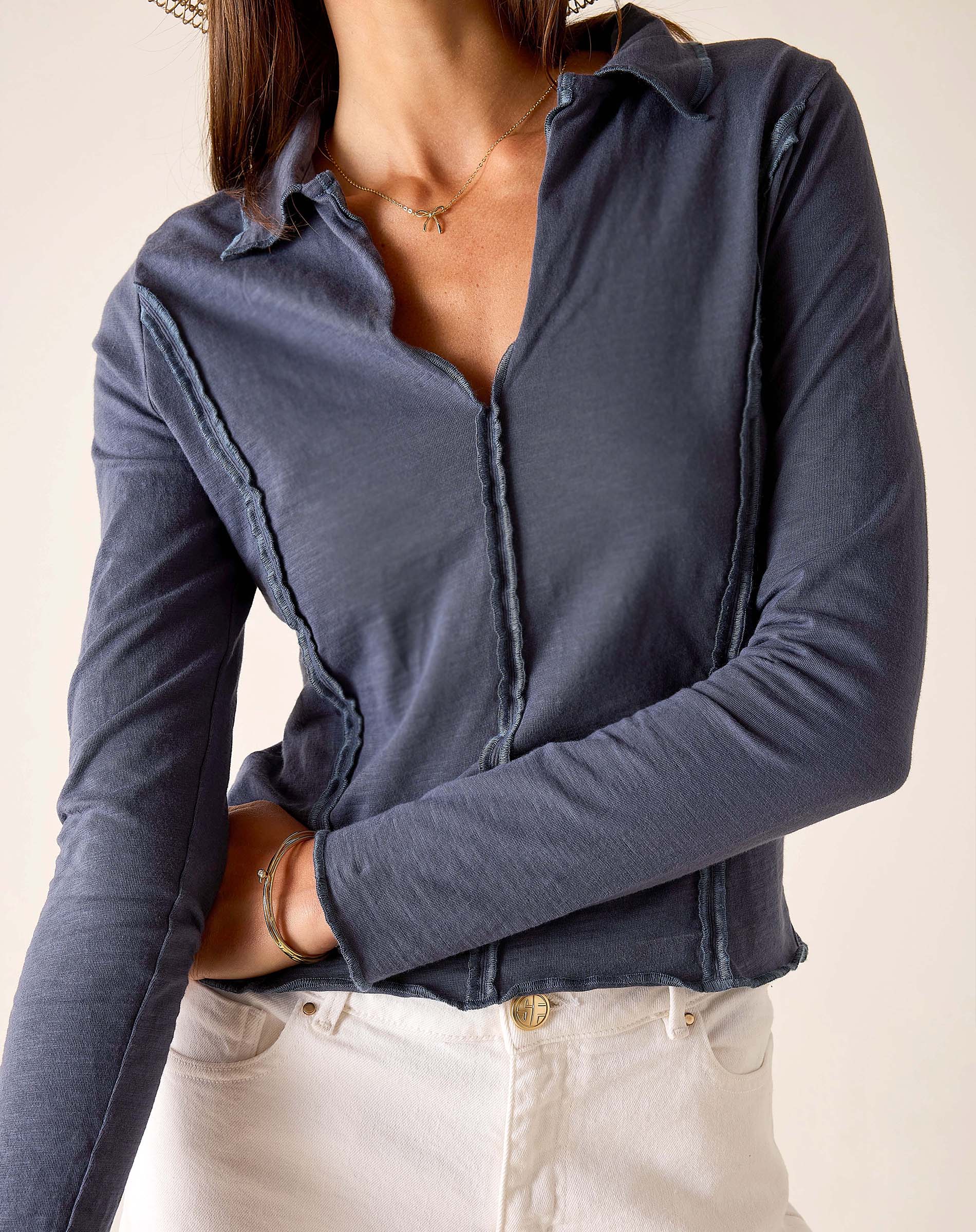 Atlas blue relaxed fit jersey knit polo tee with ruffled placket and hem.