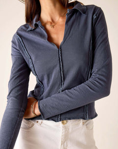 Atlas blue relaxed fit jersey knit polo tee with ruffled placket and hem.