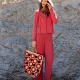 Women's travel-friendly cayenne red zip-up knit polo shirt and matching lounge pants set.