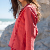 Cayenne colored linen blend polo tee with a stand collar and buttons.
