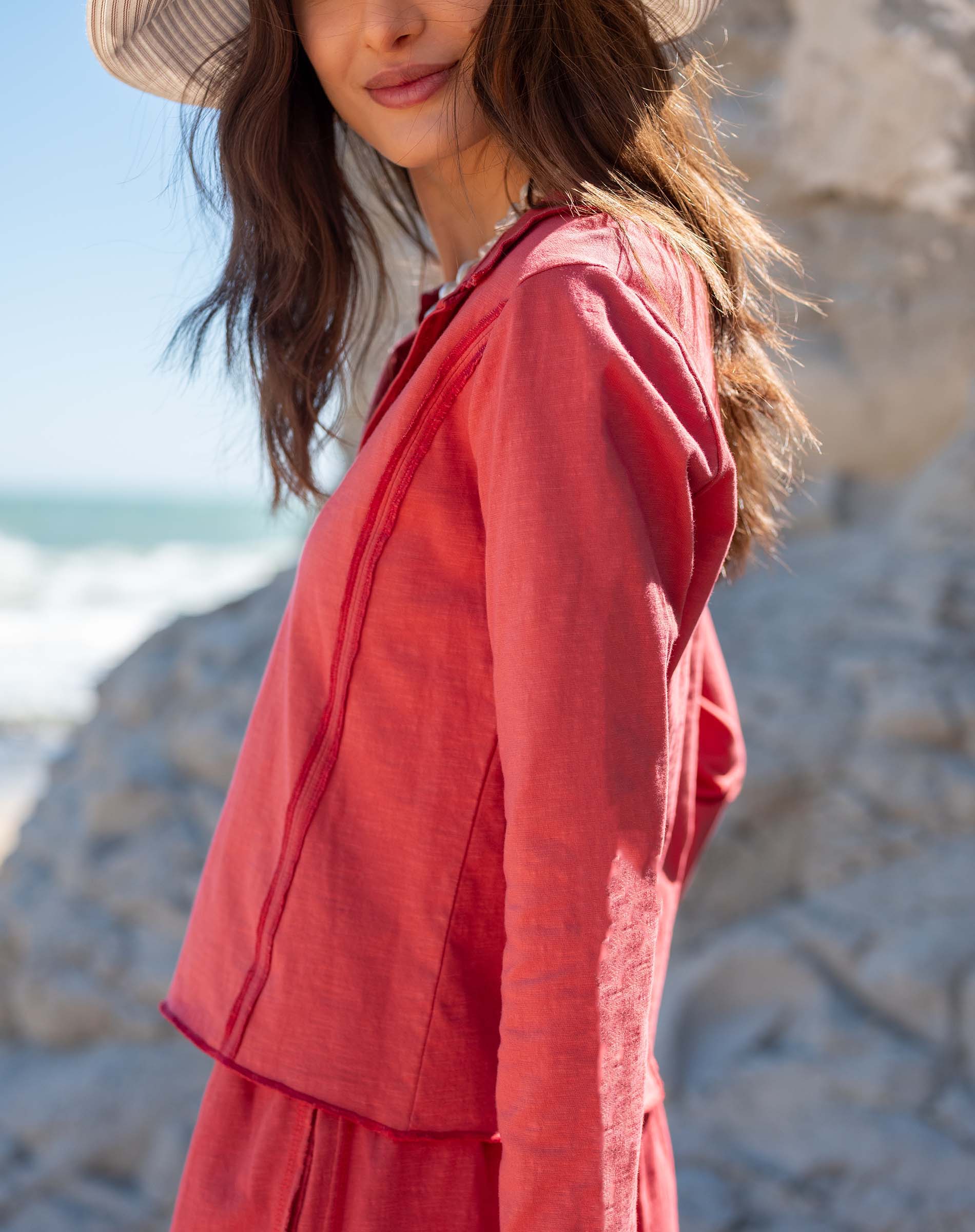 Cayenne colored linen blend polo tee with a stand collar and buttons.
