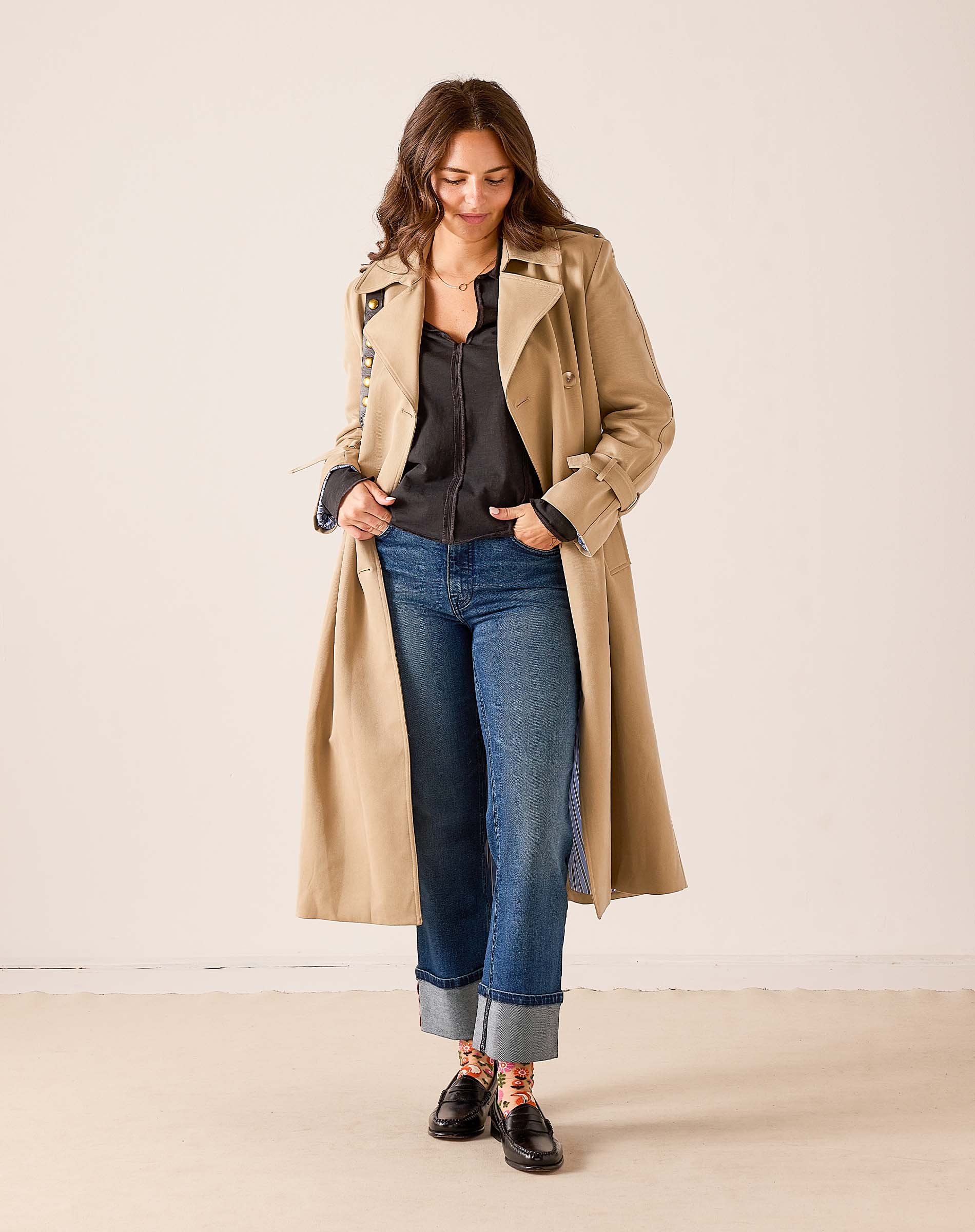 Khaki longline trench coat with belted waist and lapels.