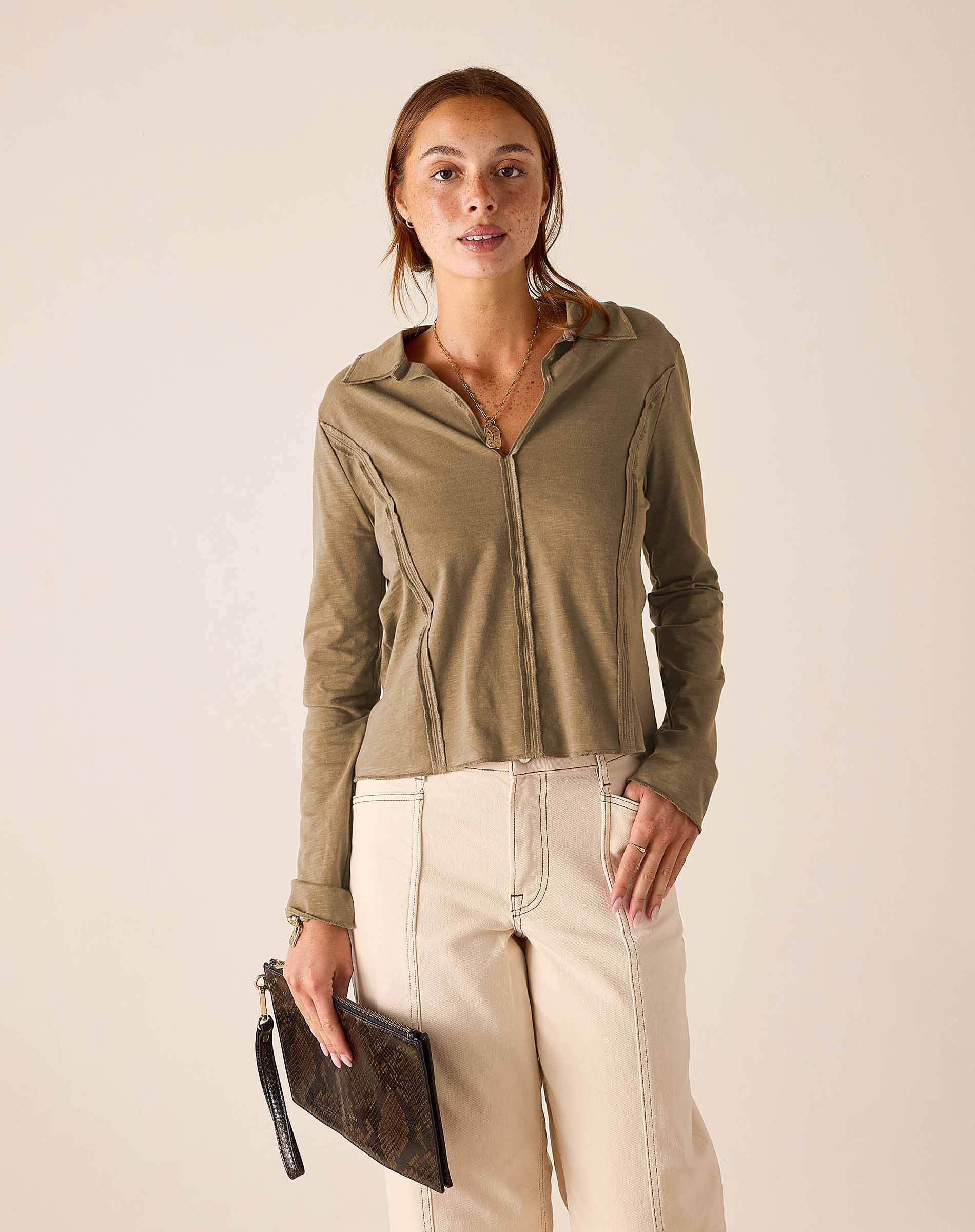 Nutmeg brown polo tee with a full-length zipper and ruffle details.