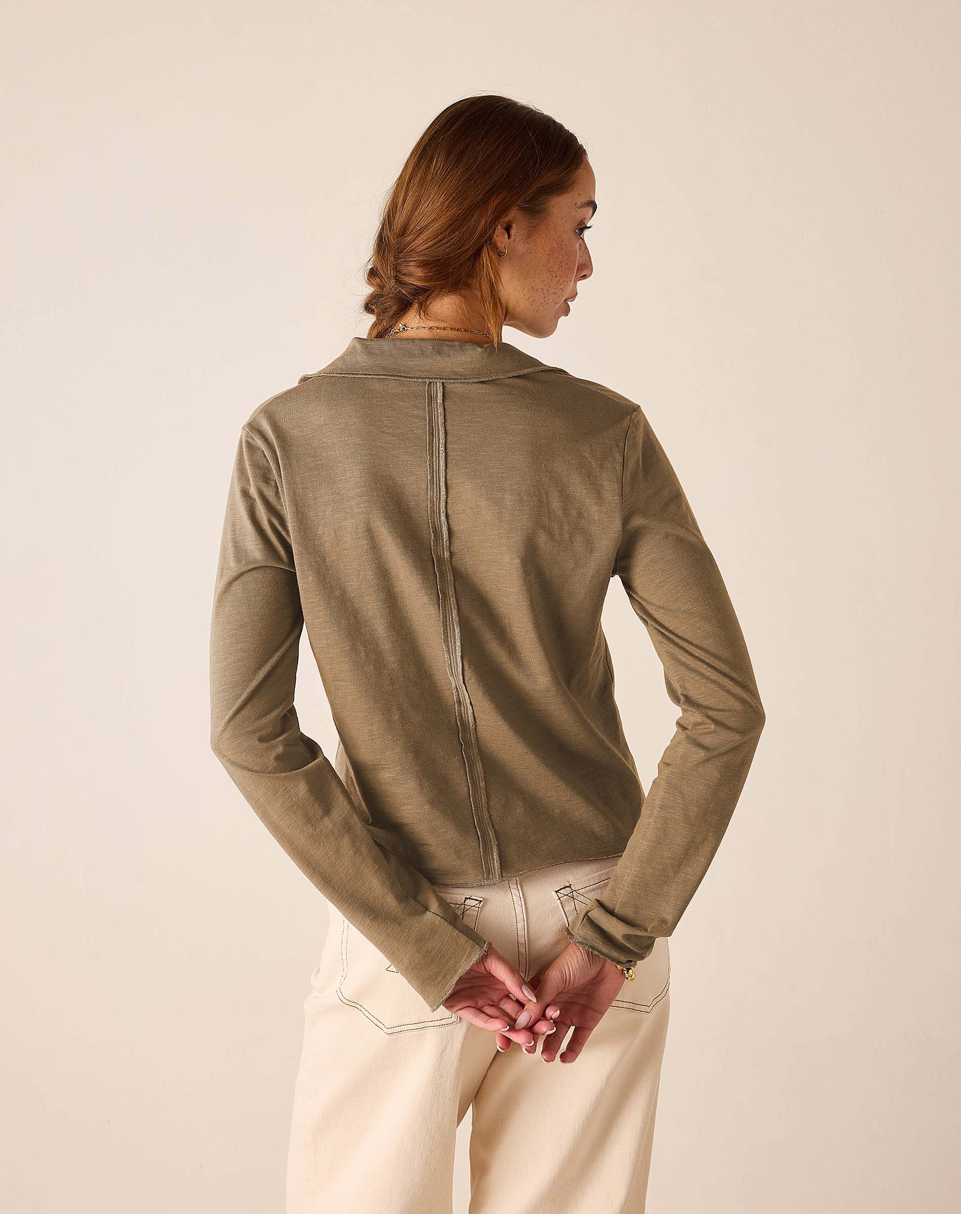 Back view of women's travel-friendly nutmeg polo tee.