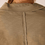 Nutmeg colored ribbed knit polo tee with a high neck and buttoned placket.