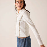 White ribbed cotton polo tee featuring a buttoned placket and structured silhouette.