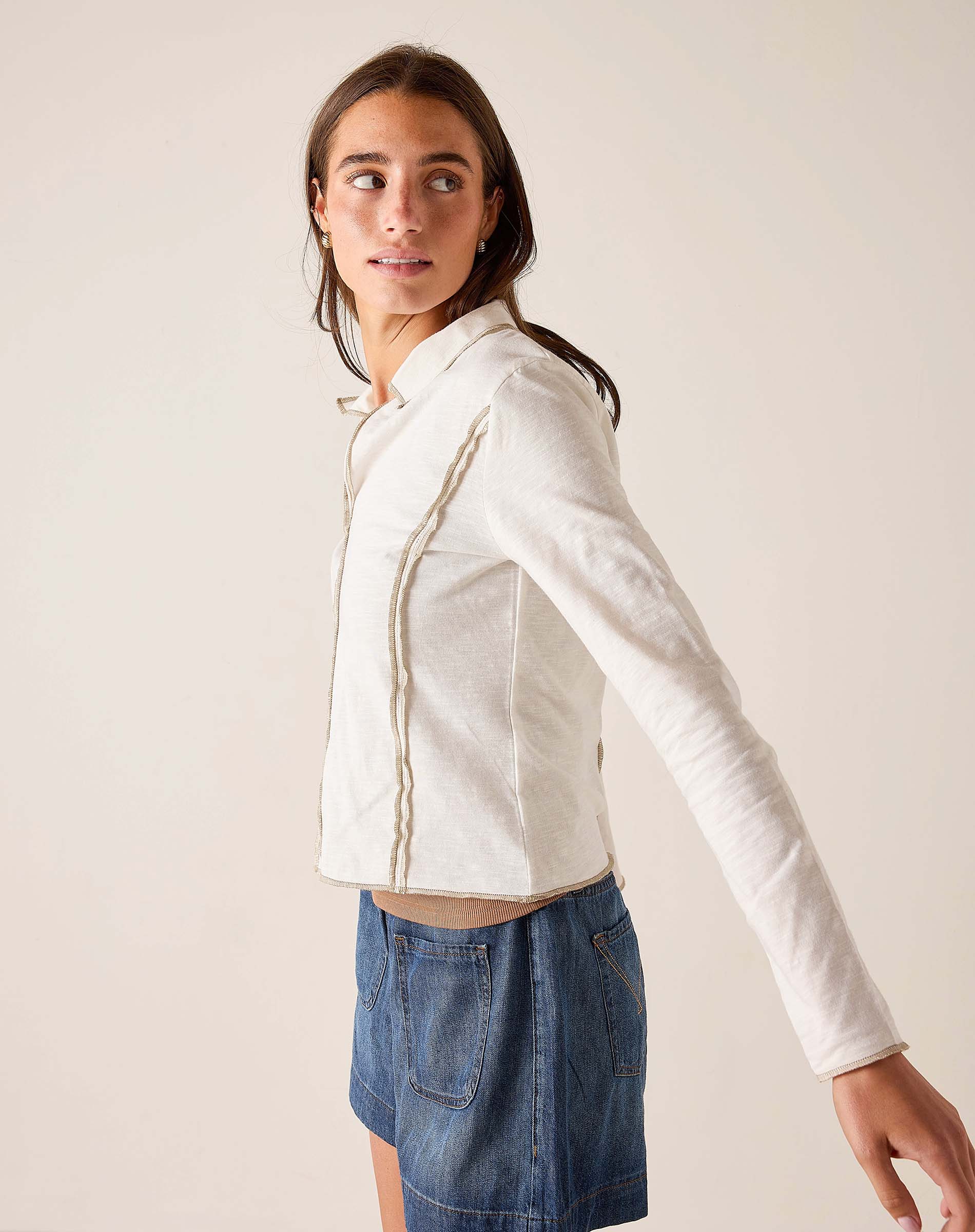 White ribbed cotton polo tee featuring a buttoned placket and structured silhouette.