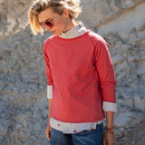 Cayenne red raglan tee with a layered white printed shirt underneath.
