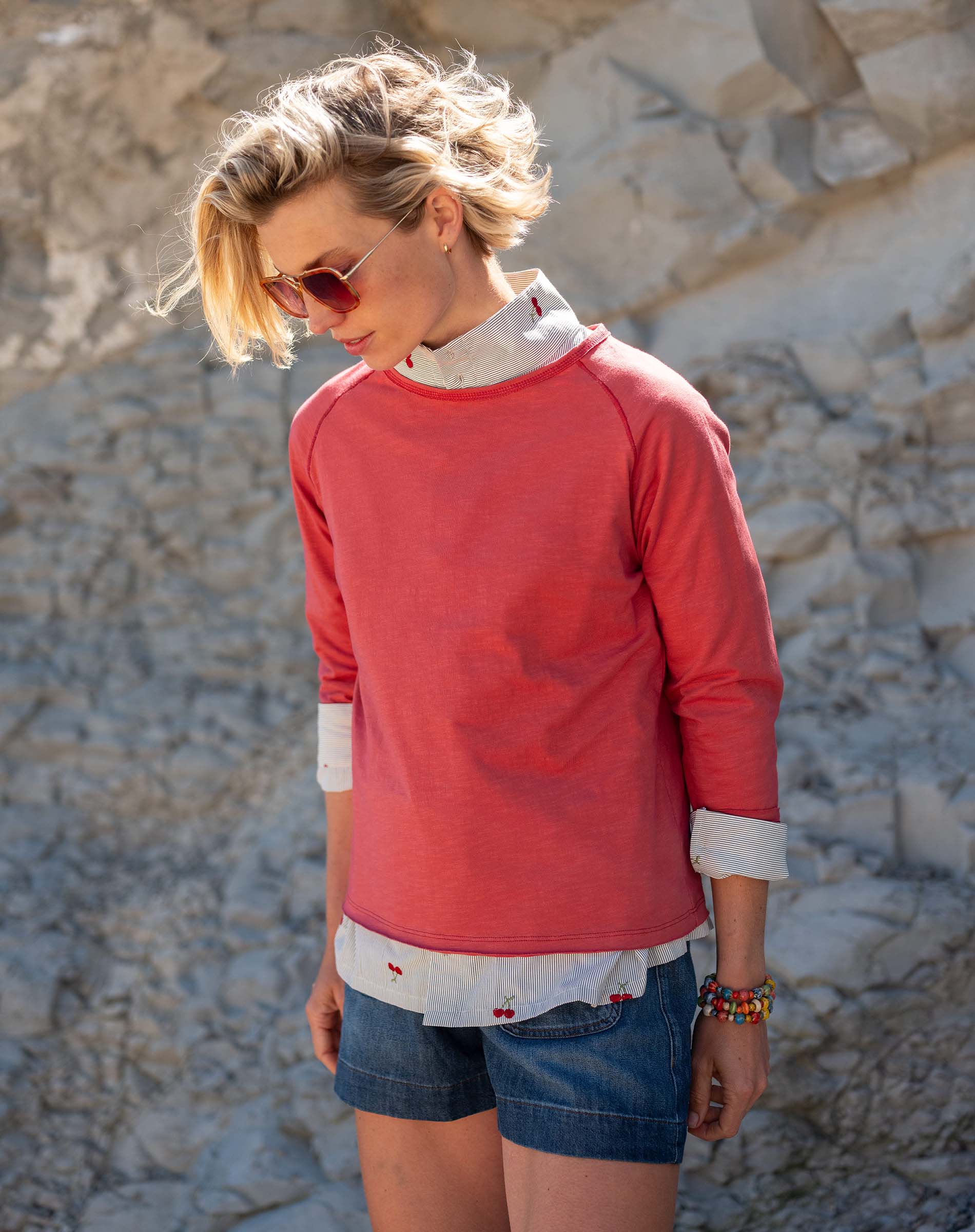 Cayenne red raglan tee with a layered white printed shirt underneath.