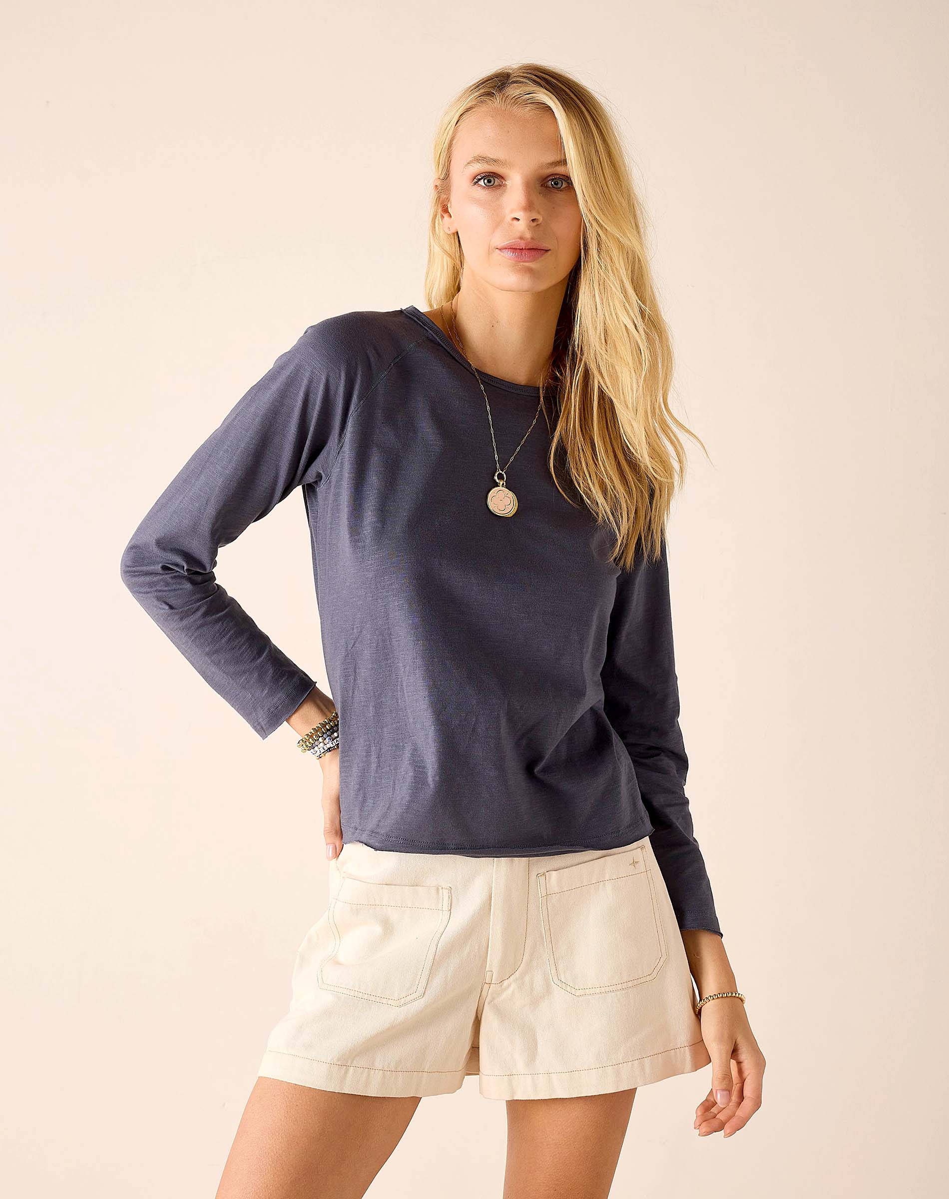 Navy blue raglan tee with long sleeves and a relaxed fit.