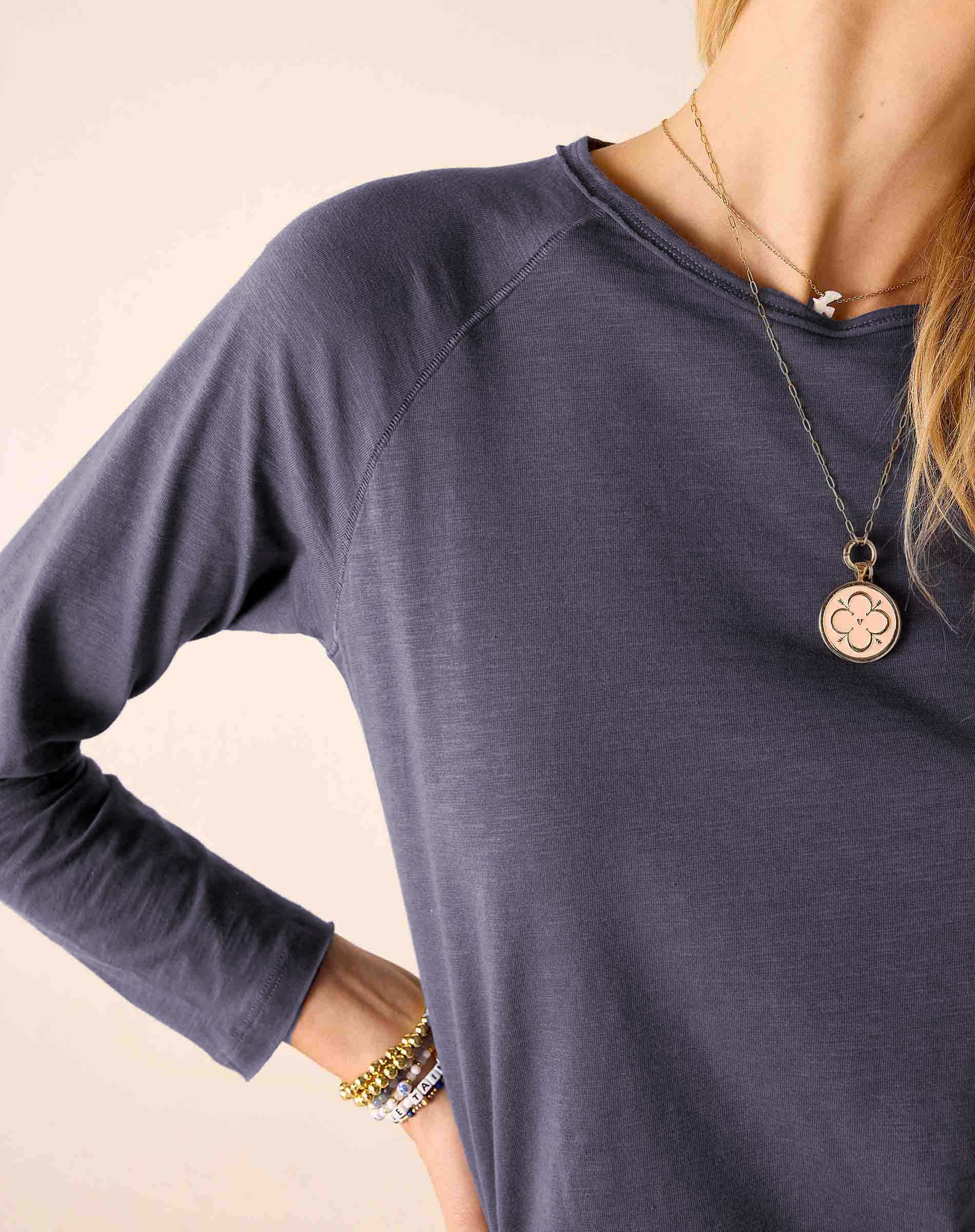Navy blue raglan tee with a soft knit texture and ribbed neckline.