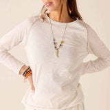 White raglan tee with a subtle heathered finish and a wide boatneck neckline.