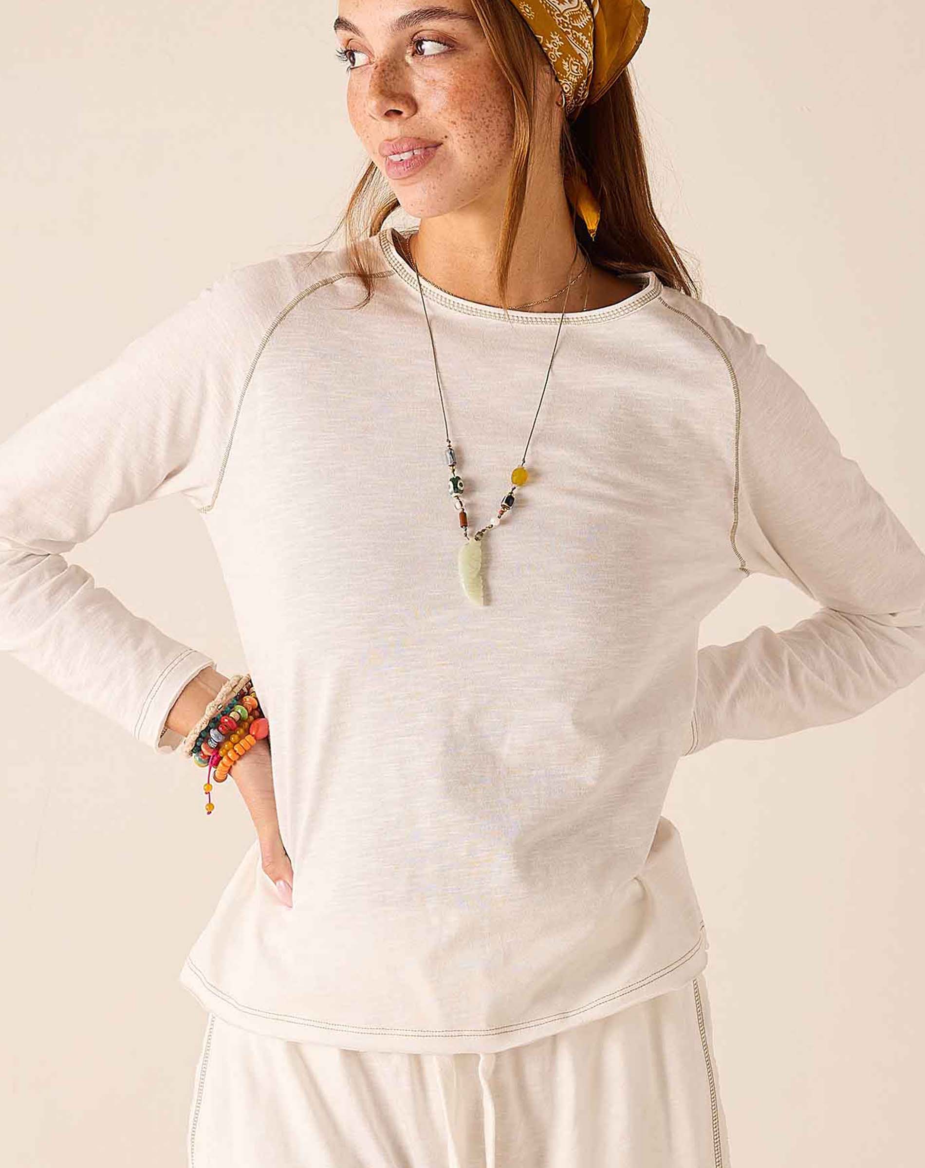 White raglan tee with a subtle heathered finish and a wide boatneck neckline.