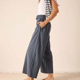 Atlas blue wide-leg relaxed fit linen blend pants featuring a gathered elastic waistband and deep side pockets.