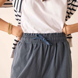 Atlas blue relaxed fit linen-blend pants with a drawstring waist and matching light pink tee.