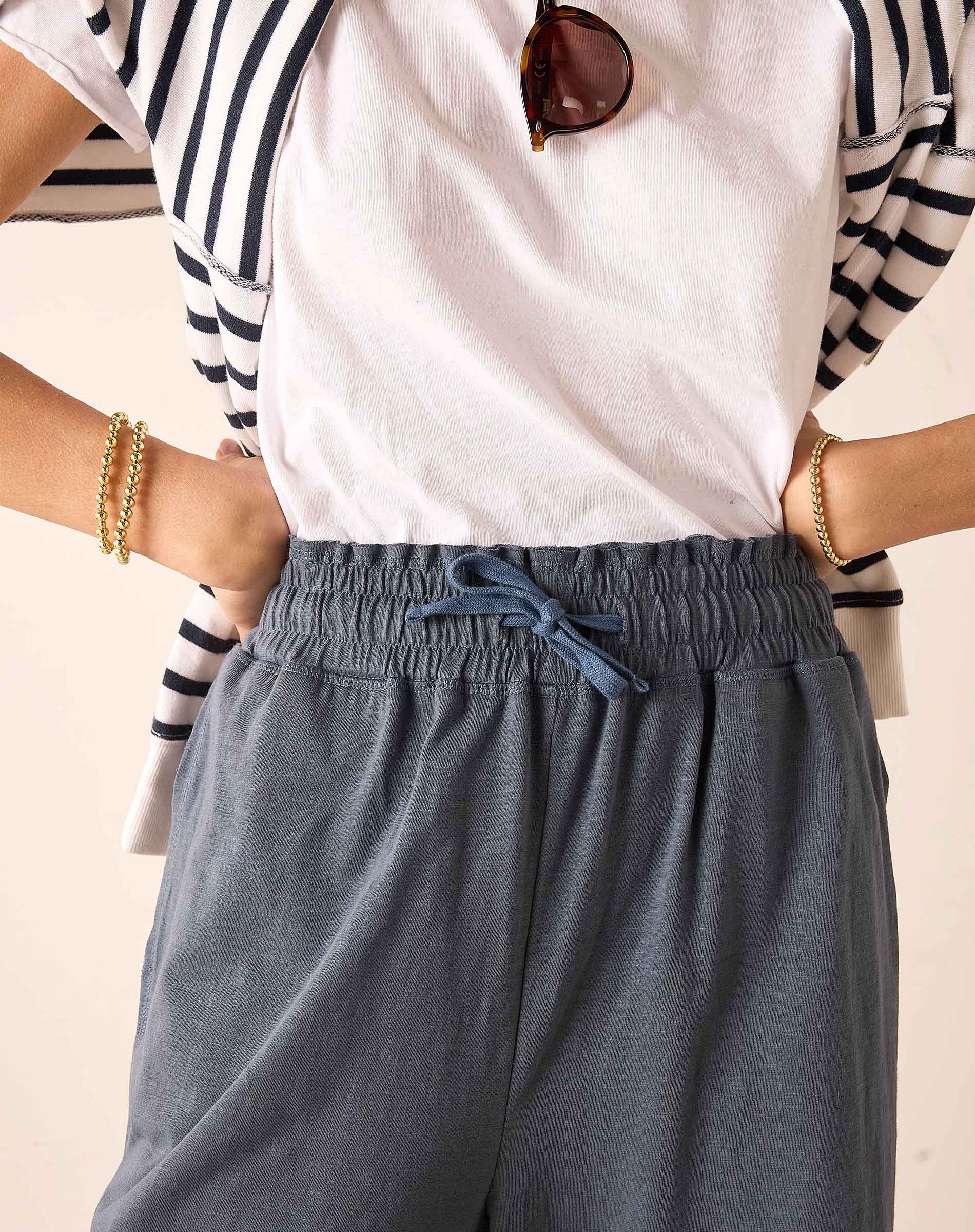 Atlas blue relaxed fit linen-blend pants with a drawstring waist and matching light pink tee.