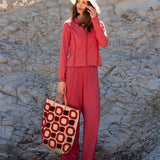 Cayenne red set featuring a zip-up top and matching pants with a graphic print.