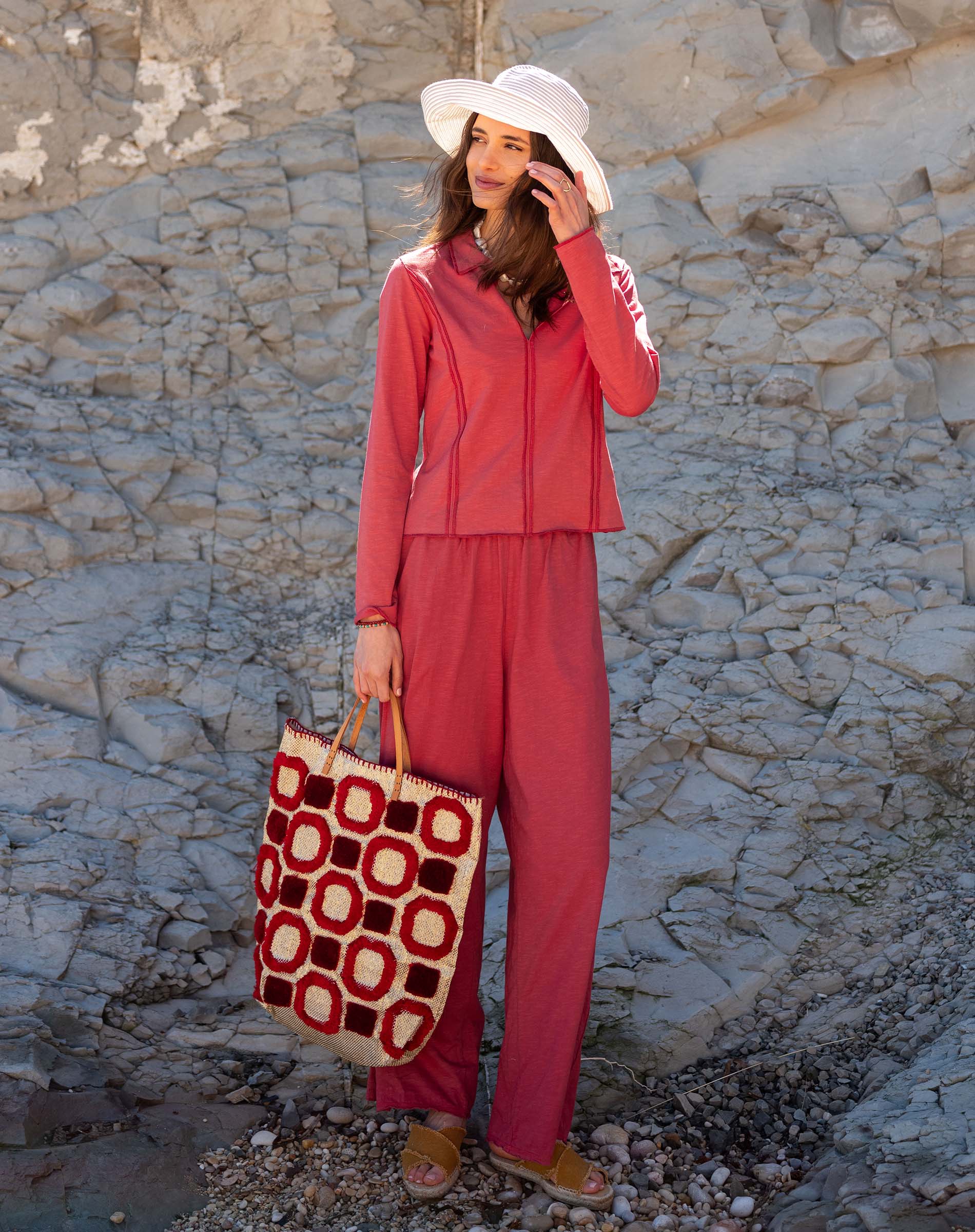 Cayenne red set featuring a zip-up top and matching pants with a graphic print.