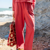 Cayenne red relaxed fit linen blend Trouvaille tee and matching pants set featuring a buttoned front.
