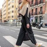 Graphite gray knit tee and matching wide-leg trousers with a cream oversized shawl.