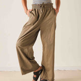 Ladies' travel-ready nutmeg wide-leg linen trousers with elasticized drawstring waist and side pockets.