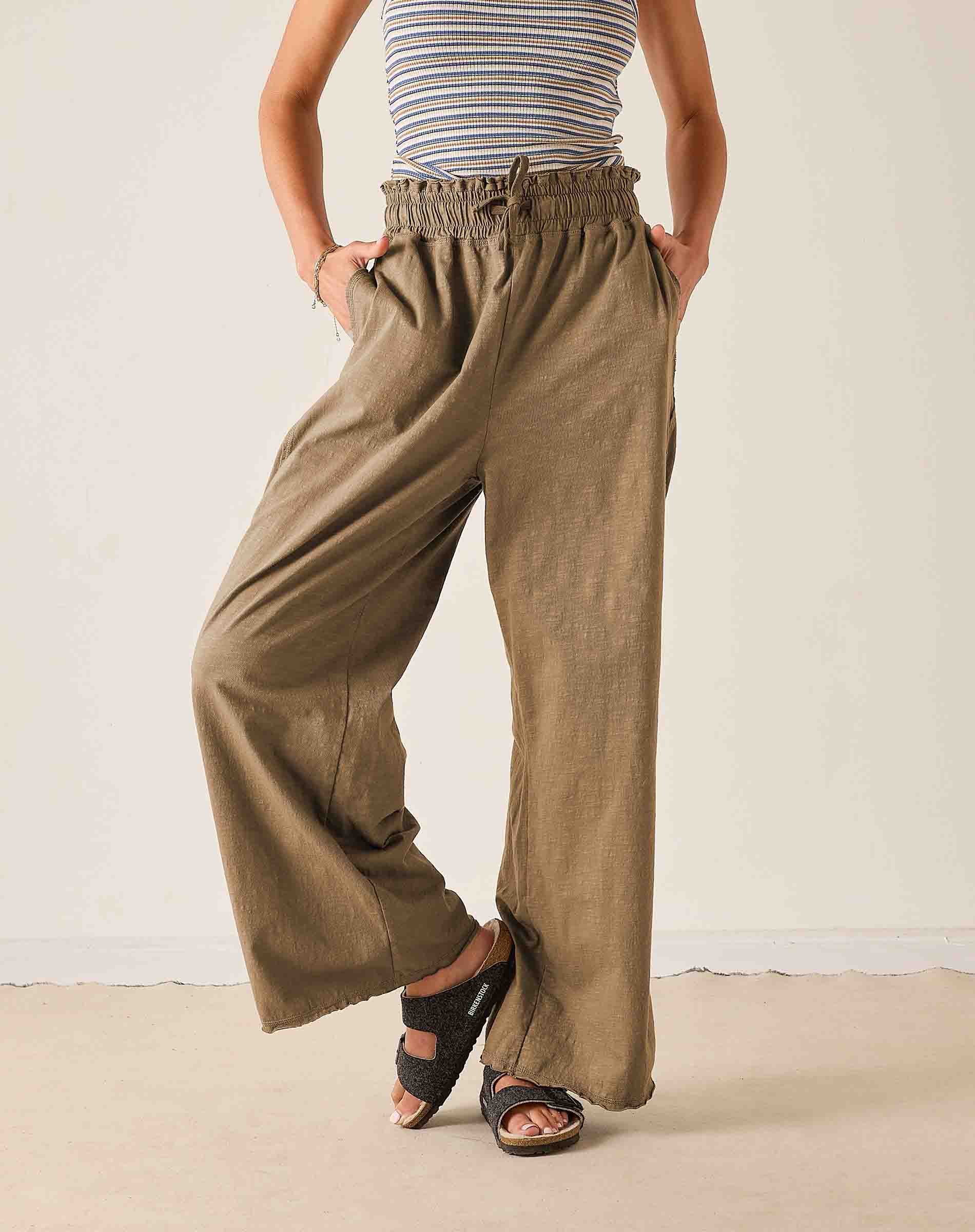 Ladies' travel-ready nutmeg wide-leg linen trousers with elasticized drawstring waist and side pockets.