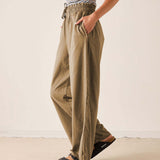 Nutmeg wide-leg trousers in a textured knit fabric with an elasticated waist and drawstring.