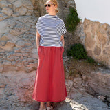 Women's travel-friendly cayenne long maxi skirt paired with a black and white striped short sleeve tee.