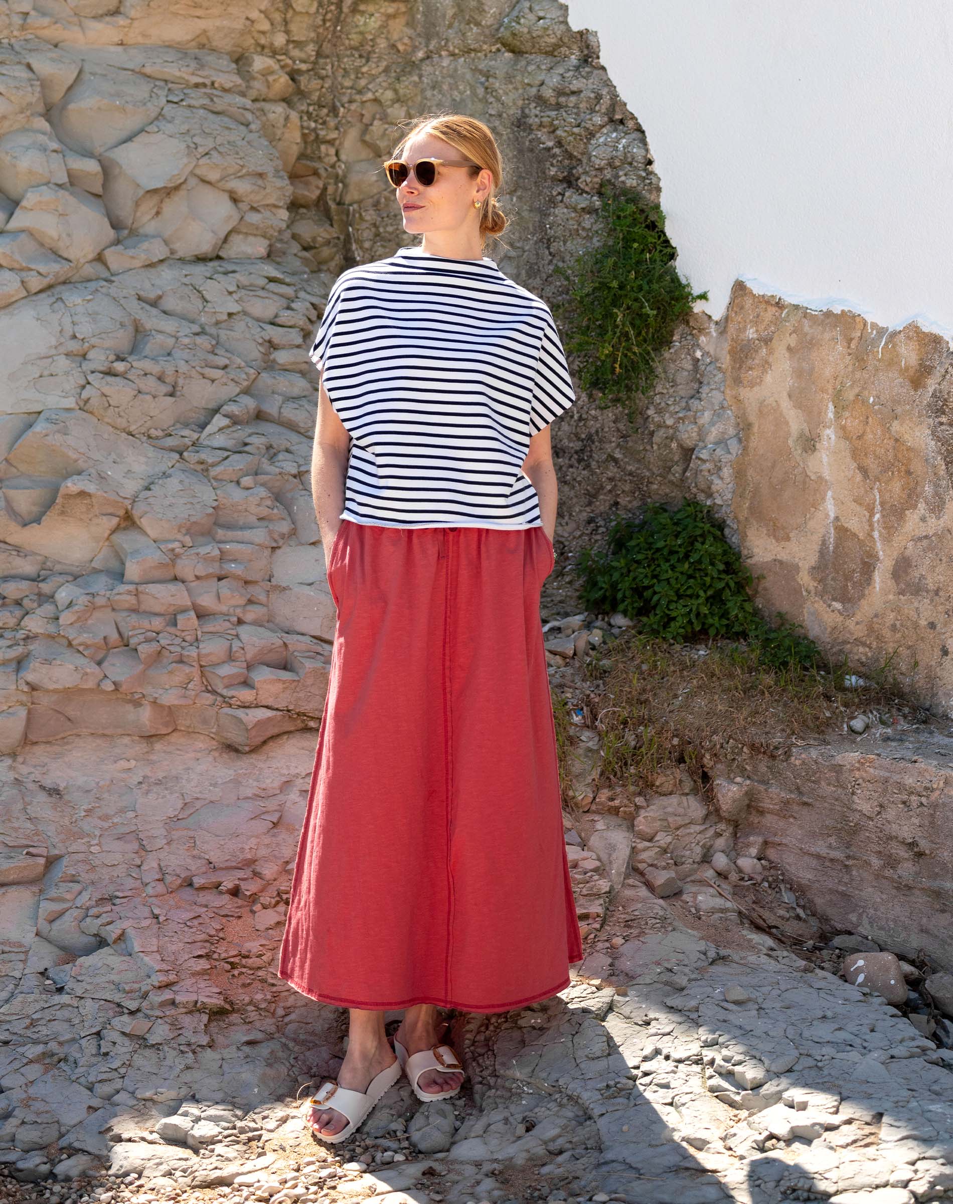 Women's travel-friendly cayenne long maxi skirt paired with a black and white striped short sleeve tee.