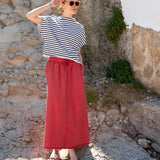 Navy and white striped short sleeve tee paired with a cayenne red maxi skirt.