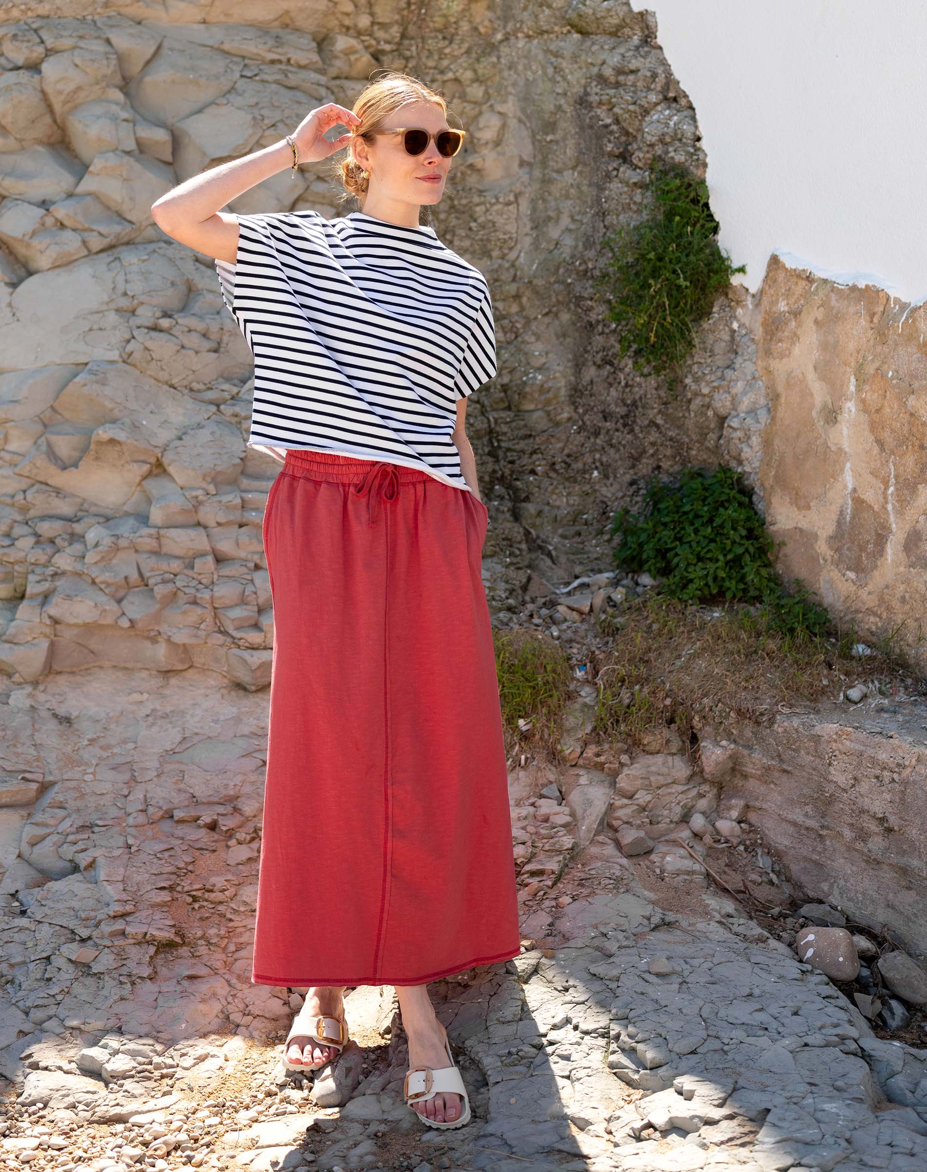 Navy and white striped short sleeve tee paired with a cayenne red maxi skirt.