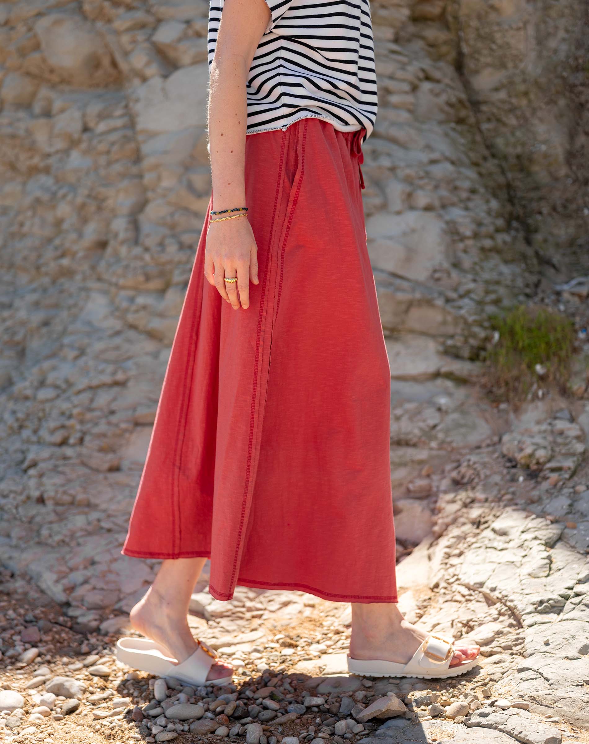 Cayenne terracotta orange linen midi skirt with high waist and wide leg flowy silhouette.