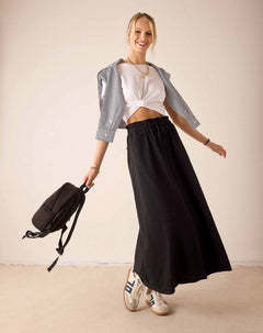 Women's travel-friendly graphite long flowing skirt and white cropped tee paired with a light grey linen shirt.