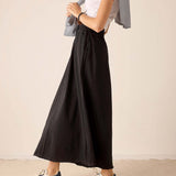 Graphite maxi skirt in a flowy linen blend with an elastic waistband and wide hem.